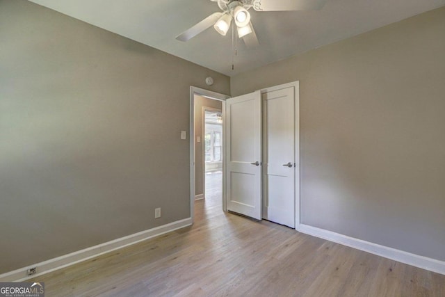 unfurnished bedroom featuring ceiling fan and light hardwood / wood-style floors