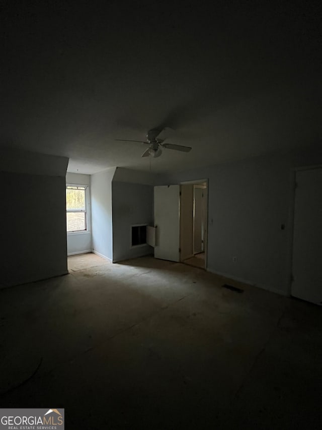 unfurnished living room with ceiling fan