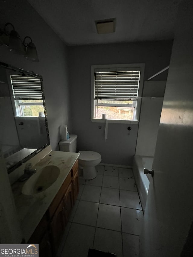 full bathroom with shower / bathtub combination, tile patterned floors, vanity, and toilet