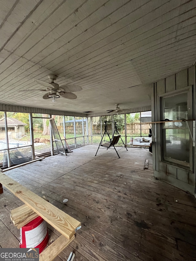 interior space with ceiling fan