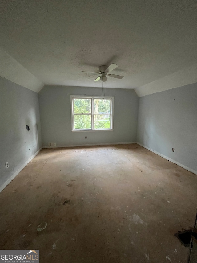 additional living space featuring lofted ceiling, ceiling fan, and a textured ceiling