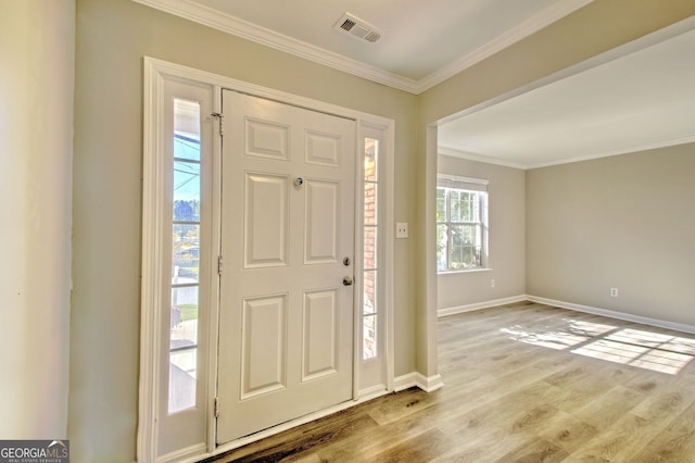 foyer entrance featuring light hardwood / wood-style floors and crown molding