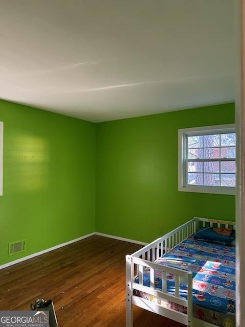 bedroom with hardwood / wood-style flooring