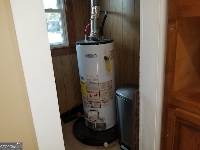 utility room featuring water heater