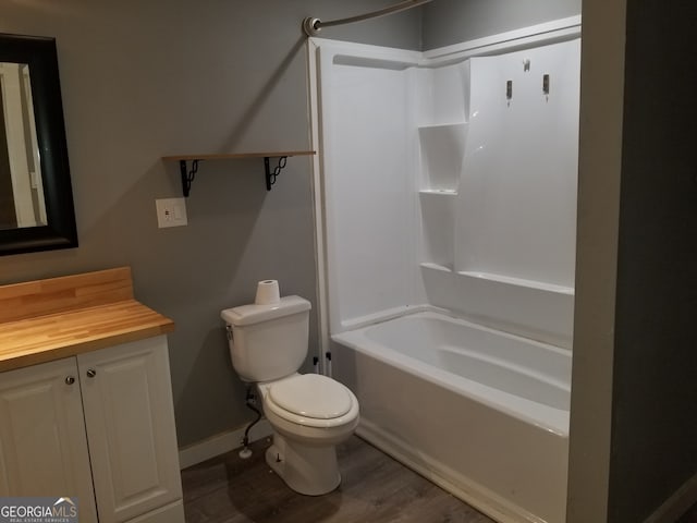 full bathroom with hardwood / wood-style flooring, toilet, vanity, and shower / washtub combination