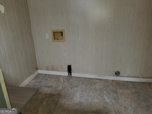 clothes washing area with hookup for a washing machine and wood walls