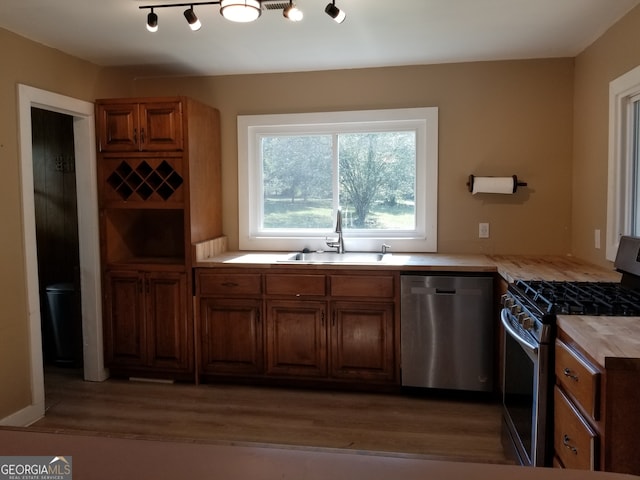 kitchen featuring wooden counters, dark wood-type flooring, sink, and stainless steel appliances