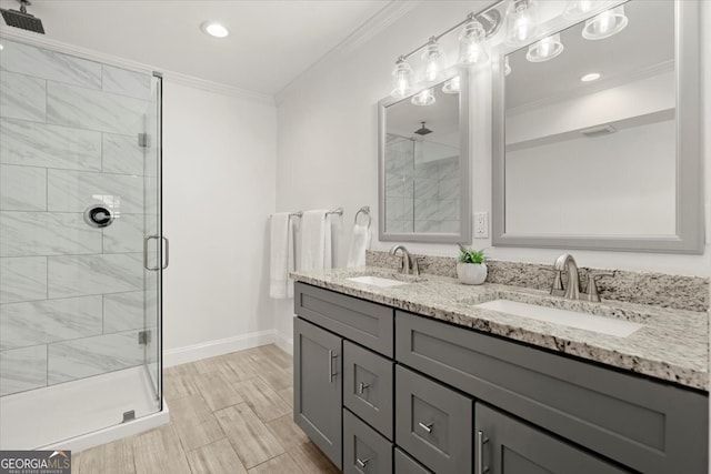 bathroom with walk in shower, crown molding, hardwood / wood-style flooring, and vanity