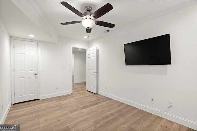 unfurnished bedroom featuring ceiling fan, light hardwood / wood-style flooring, and ornamental molding