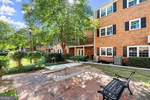 view of patio featuring a balcony and central AC