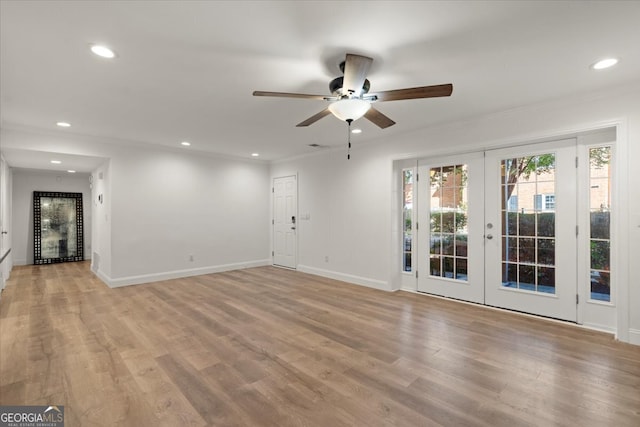 unfurnished room with crown molding, ceiling fan, french doors, and light hardwood / wood-style floors