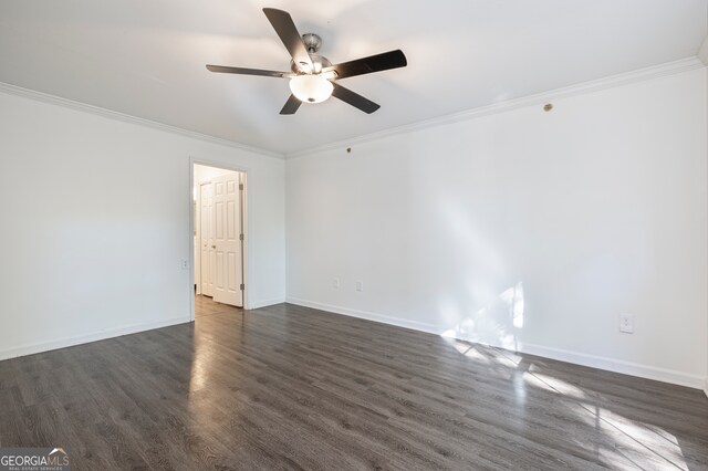 spare room featuring crown molding, dark hardwood / wood-style floors, and ceiling fan