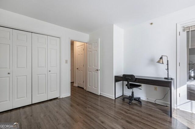 home office with dark hardwood / wood-style floors