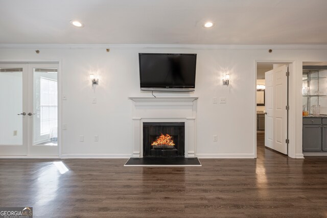 unfurnished living room with french doors, dark hardwood / wood-style floors, and crown molding