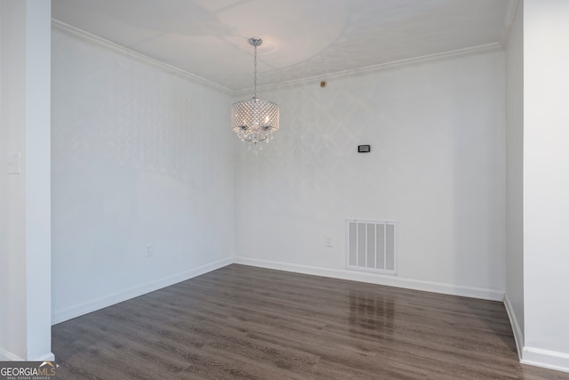 empty room with crown molding and dark hardwood / wood-style flooring