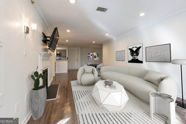 living room featuring ornamental molding and hardwood / wood-style floors