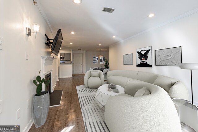 living room with ornamental molding and dark hardwood / wood-style flooring