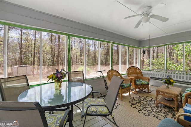 sunroom featuring ceiling fan