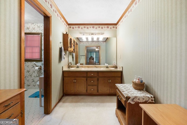 bathroom featuring crown molding, toilet, vanity, and a textured ceiling