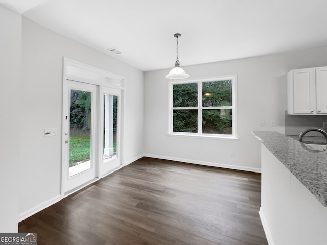 unfurnished dining area with dark wood-type flooring and sink