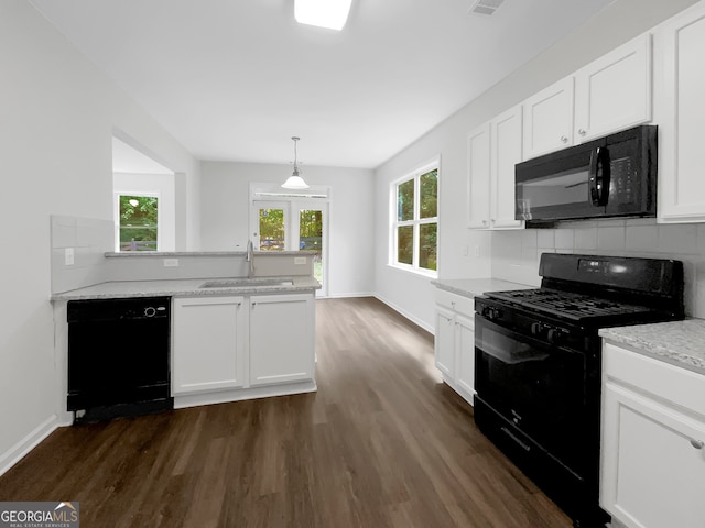 kitchen featuring black appliances, plenty of natural light, sink, and white cabinets