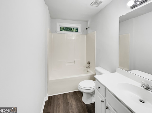 full bathroom with wood-type flooring, shower / bathtub combination, vanity, and toilet