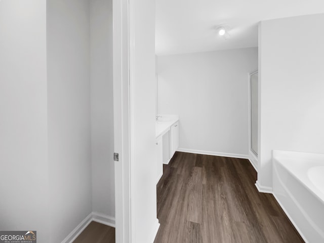 bathroom featuring wood-type flooring, separate shower and tub, and vanity