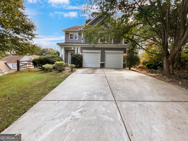 view of front of house with a garage and a front lawn