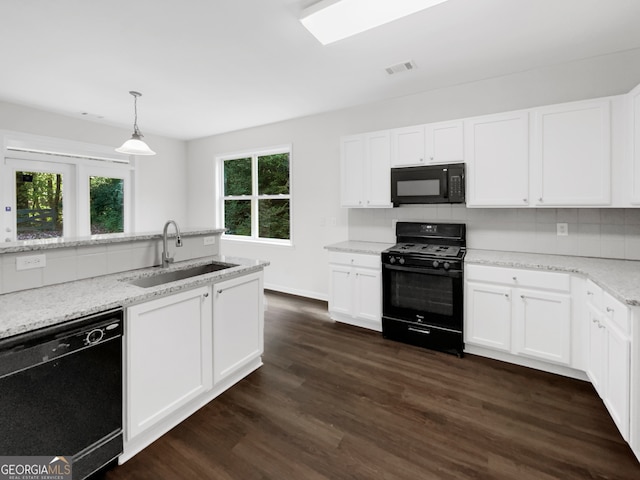 kitchen with white cabinets, sink, decorative light fixtures, dark wood-type flooring, and black appliances