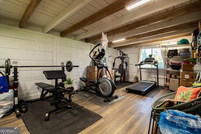 exercise room featuring wood ceiling and hardwood / wood-style floors