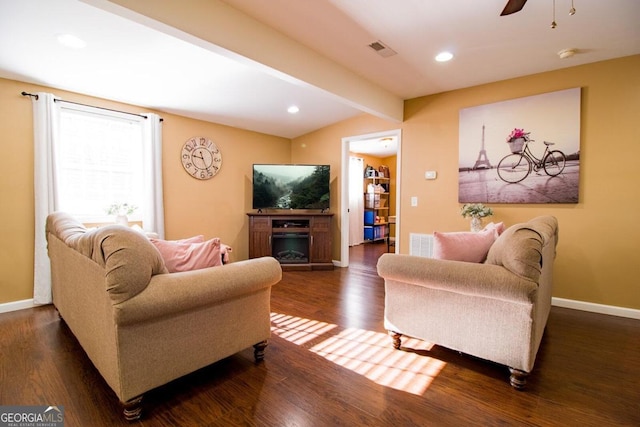 living room with dark wood-type flooring, lofted ceiling with beams, and ceiling fan