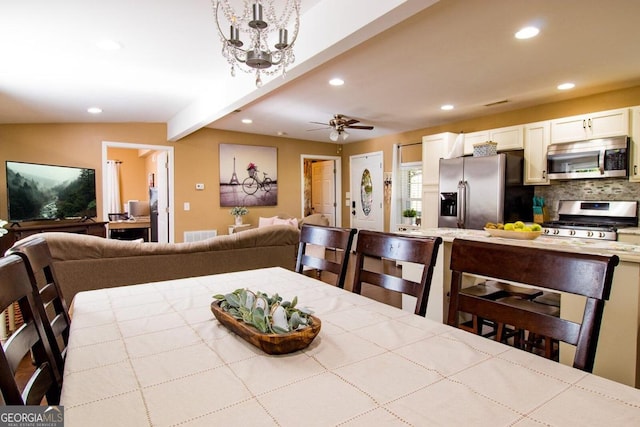 dining area with ceiling fan with notable chandelier and vaulted ceiling with beams