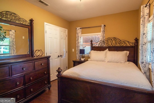 bedroom with a closet and dark wood-type flooring