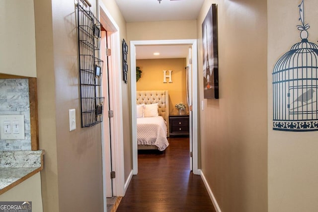 hallway with dark hardwood / wood-style flooring