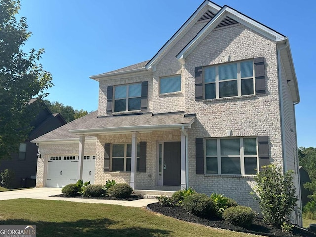 craftsman-style home with covered porch, a front yard, and a garage