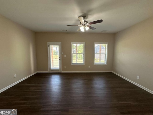 unfurnished room with dark wood-type flooring and ceiling fan