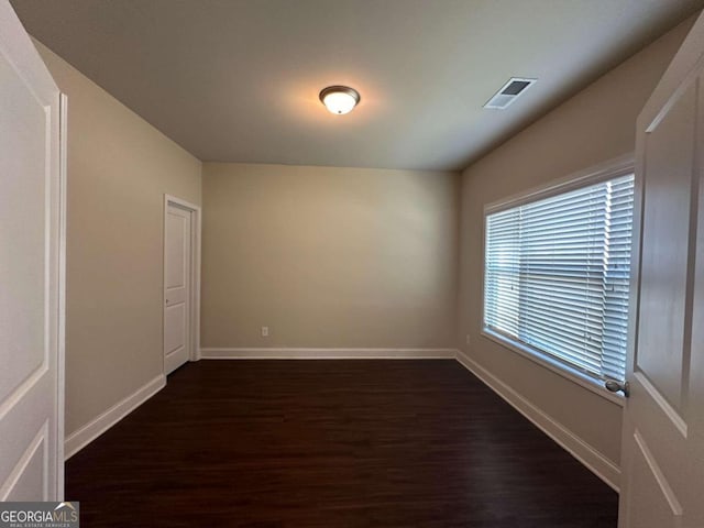 unfurnished room with dark hardwood / wood-style floors