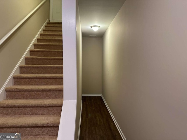 staircase with wood-type flooring