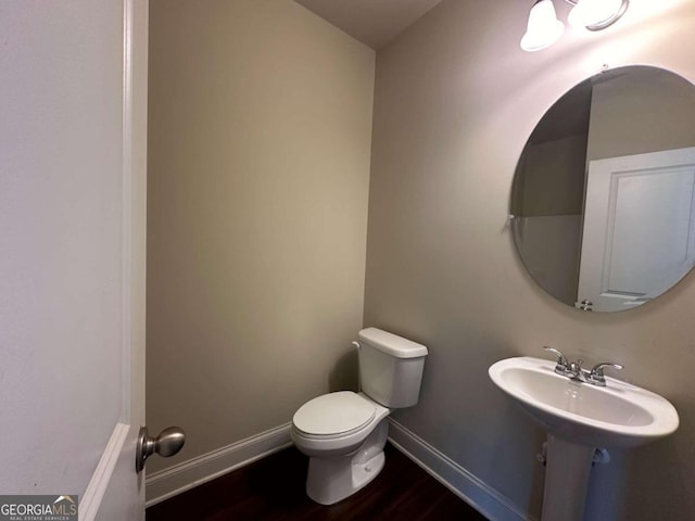 bathroom with wood-type flooring and toilet