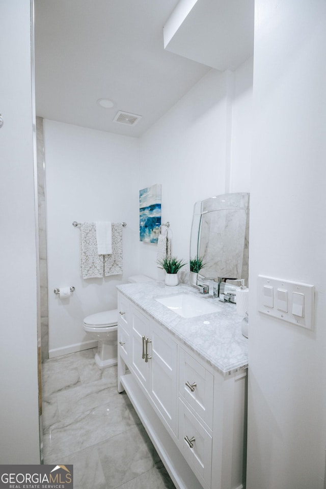 1466 Hardin Ave, Atlanta, GA 30337 - bathroom featuring vanity, toilet, and marble look tile flooring