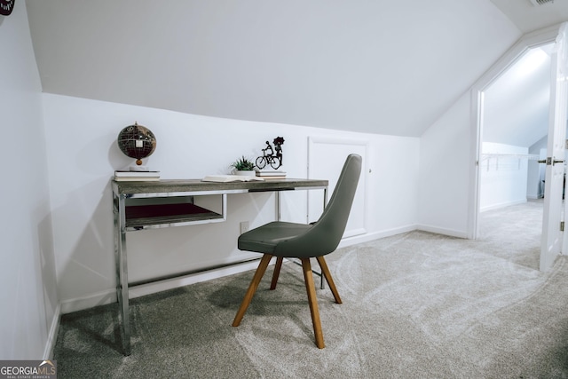 home office with lofted ceiling and carpet