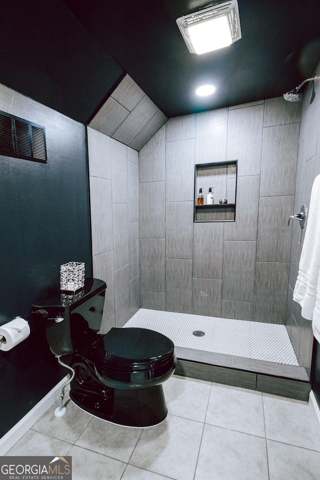 1466 Hardin Ave, Atlanta, GA 30337 - bathroom featuring tiled shower, tile patterned floors, toilet, and vaulted ceiling