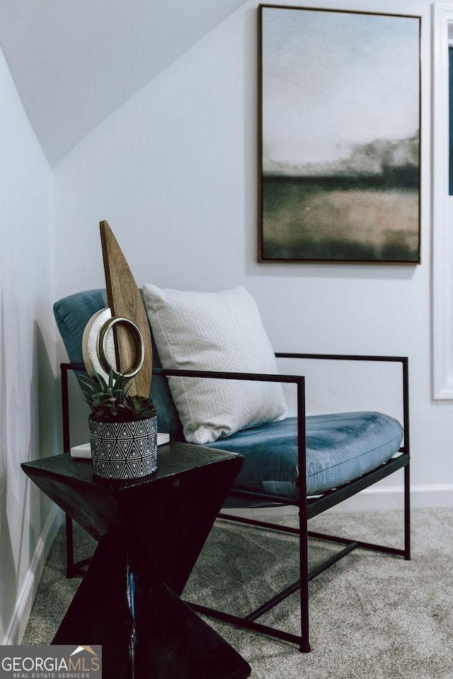 living area with carpet floors and vaulted ceiling