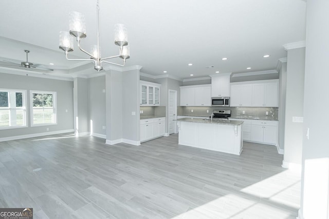 133 Amanda Trce, Kingsland, GA 31548 - kitchen with appliances with stainless steel finishes, open floor plan, a chandelier, a ceiling fan, and decorative backsplash