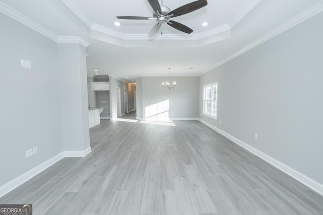 133 Amanda Trce, Kingsland, GA 31548 - unfurnished living room featuring a chandelier, a tray ceiling, recessed lighting, ceiling fan, and ornamental molding