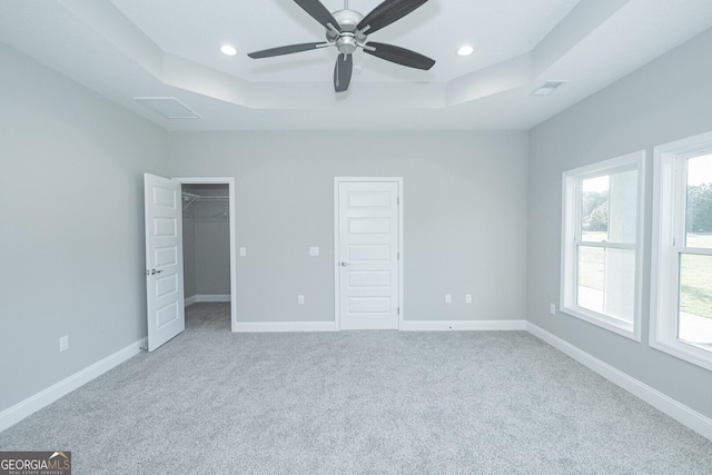133 Amanda Trce, Kingsland, GA 31548 - unfurnished bedroom featuring a tray ceiling, multiple windows, carpet flooring, and recessed lighting