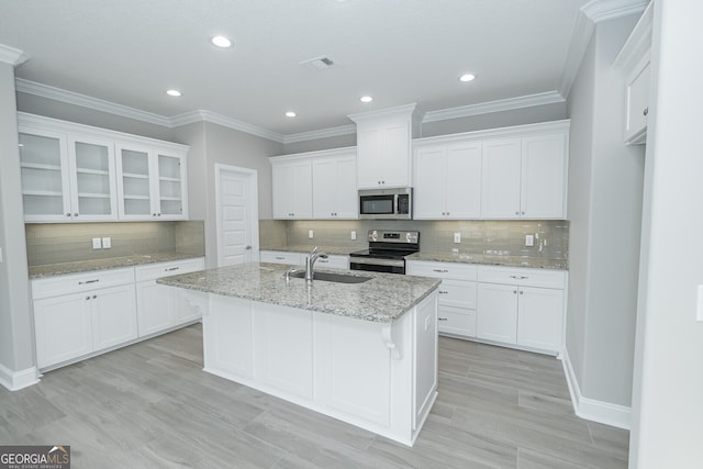 kitchen featuring light stone counters, appliances with stainless steel finishes, sink, and white cabinetry