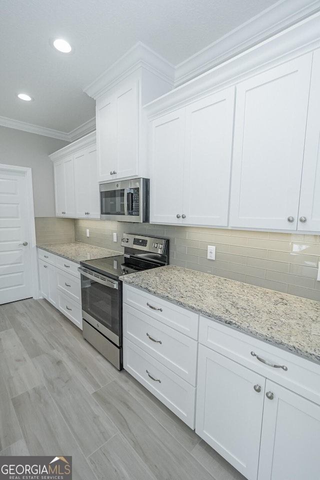 133 Amanda Trce, Kingsland, GA 31548 - kitchen with appliances with stainless steel finishes, crown molding, white cabinets, backsplash, and recessed lighting