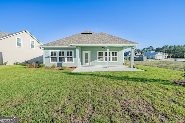 133 Amanda Trce, Kingsland, GA 31548 - back of property featuring a patio, a yard, and roof with shingles