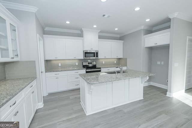 133 Amanda Trce, Kingsland, GA 31548 - kitchen featuring stainless steel appliances, white cabinetry, a center island with sink, tasteful backsplash, and recessed lighting